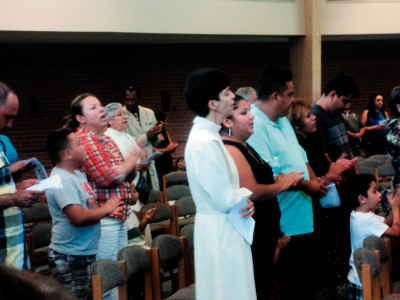 Guadalupan Sisters Lourdes González (center) and María Josefa Garcia (back row) pray with the community at St. Therese Church on Aug. 31. Sister González is serving as pastoral assistant to the Hispanic community. 