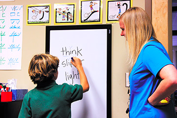 Kacey Matthews and a student at St. Anthony School in Madison use ‘coding,’ part of an Orton-Gillingham-based program of dyslexia therapy. Dyslexia affects 80 percent of those identified with learning disabilities, but students can still excel with the right therapy. (Photo by Jennifer Kelemen)