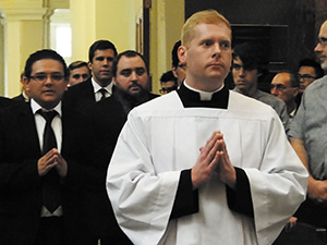 Seminarian Jason Johnston of Vicksburg prepares to lead in those who will receive the ministry of lectors. He is set to be ordained a deacon in 2015.