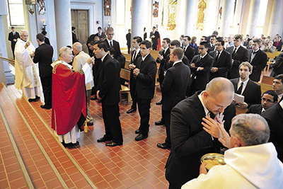 St. Joseph seminarians, including Andrew Bowden of the Diocese of Jackson, second from last in line, receive Holy Communion during the Mass. The seminary college has had record classes in the past couple of years. 
