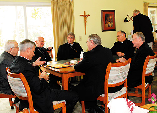 Bishop Joseph Kopacz, center, and retired Bishop William Houck relax following a brunch honoring the anniversary. The bishops are joined by, from Bishop Kopacz’s left, Father Chet Artysiewicz, president of Glenmary; Msgr. Elvin Sunds of the Diocese of Jackson; Bishop Gregory Hartmayer of the Diocese of Savannah; Bishop Joseph Strickland of the Diocese of Tyler; and Glenmary Father Wil Steinbacher. Bishop Strickland served as the keynote speaker at a dinner held the previous evening. (Photo courtesy of Jean Bach)