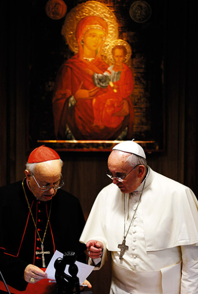 Pope Francis talks with Italian Cardinal Lorenzo Baldisseri, general secretary of the Synod of Bishops, during the morning session on the final day of the extraordinary Synod of Bishops on the family at the Vatican Oct. 18. (CNS photo/Paul Haring)