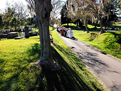 Natchez St. Mary Basilica parishioners process to Catholic Hill in the City Cemetery on Sunday, Nov. 2, the Feast of All Souls to pray and remember their Catholic ancestors. November is the month in which we honor the dead.(Photo by Patricia Murphy)