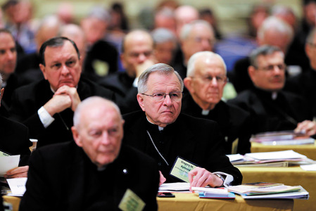 Archbishop Gregory M. Aymond of New Orleans, center, listens to a speaker Nov. 10 during the annual fall general assembly of the U.S. Conference of Catholic Bishops in Baltimore. Behind him on the left is Archbishop Thomas Rodi of Mobile, Metropolitan Archbishop for the Diocese of Jackson. (CNS photo/Bob Roller