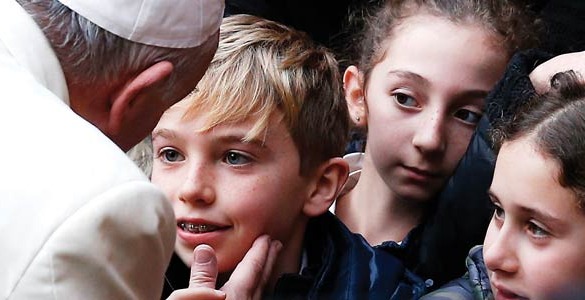 Pope Francis greets a boy as he arrives to celebrate Mass at St. Joseph Parish in Rome Dec. 14. (CNS photo/Paul Haring)