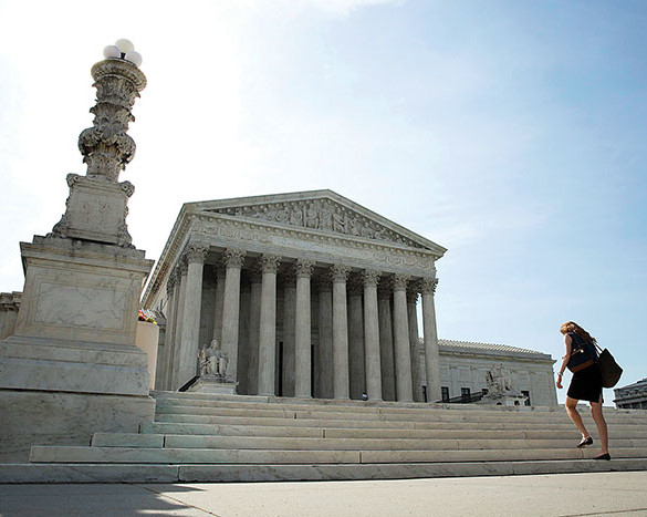 A woman walks to the U.S. Supreme Court in Washington late last year. On Oct. 6, 2014 the court declined to hear appeals on rulings striking down same-sex marriage bans. This cleared the path for same-sex marriages to be legally recognized in more states, but also caused some confusion and disappointment for those on both sides of the issue. (CNS phopto/Joshua Roberts, Reuters)