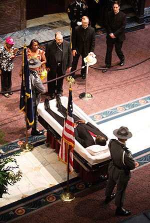 Bishop Robert E. Guglielmone of Charleston S.C., offers a prayer while paying his respects to the Rev. Clementa C. Pinckney, a pastor and state senator, inside the South Carolina Statehouse in Columbia, S.C., June 24. Rev. Pinckney, who was pastor of Emanuel African Methodist Episcopal Church in Charleston, was one of nine people shot and killed at the church June 17. (CNS photo/Mic Smith, The Catholic Miscellany)