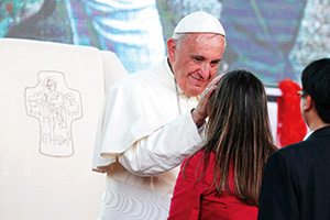 Pope Francis greets a young woman as he leads a meeting with young people along the waterfront in Asuncion, Paraguay, July 12. (CNS photo/Paul Haring)