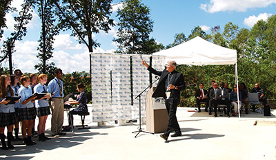 Bishop Joseph Kopacz blesses the site as the choir from Madison St. Joseph School sings at the event. (Photos and text by Maureen Smith)