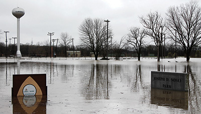 Flood waters have nearly reached the sign on the Clarksdale Municipal School District central office on Friars Point Road. Several nearby residents have evacuated their homes, which are inundated, and other residents who live in the area known as “the circle” can only get in and out of the neighborhood by boat. (Photo and text repinted with permission from Nathan Duff of the Clarksdale Press Register.) 