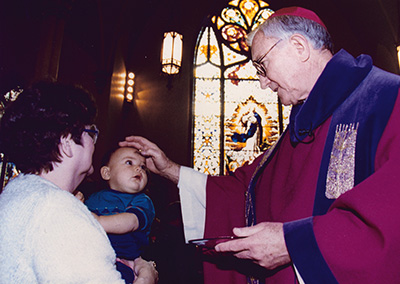 Bishop Houck places ashes on the forehead of a baby on Ash Wednesday in the cathedral in this undated photo. 