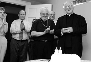Bishop Houck rejoices at a chancery celebration of his 80th birthday. (Mississippi Catholic file photos)