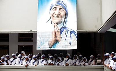A poster of Blessed Teresa of Kolkata and Missionaries of Charity are seen in Kolkata, India, in this Sept. 5, 2007, file photo. Pope Francis will declare her a saint at the Vatican Sept. 4, the conclusion of the Year of Mercy and jubilee for those engaged in works of mercy. (CNS photo/Jayanta Shaw, Reuters)