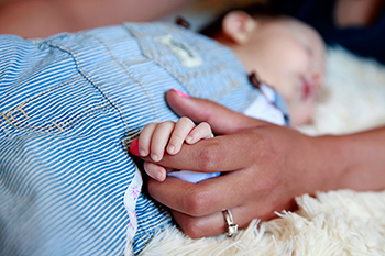 A mother comforts her infant daughter at home. In his apostolic exhortation "Amoris Laetitia" ("The Joy of Love"), Pope Francis repeated his earlier reflection on motherhood: "Mothers are the strongest antidote to the spread of self-centered individualism. ... It is they who testify to the beauty of life." Mother's Day is May 8 this year. (CNS photo/Nancy Wiechec)