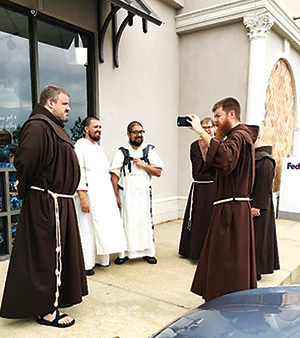 MADISON – Father Richard Goodin, OFM, records fathers Francis Orozco and Thomas Schaefgan alongside fellow Franciscans Eric, Richard, and Michael. (Photo by Paula Morgan)