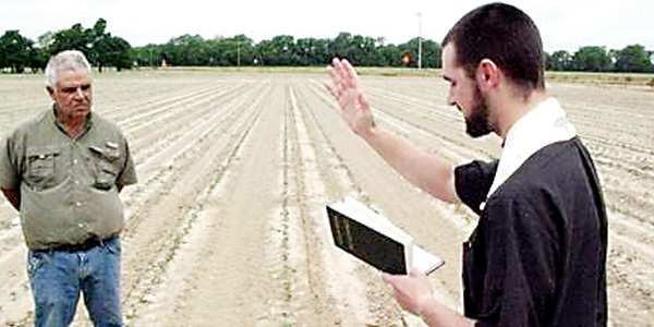 Father Thomas blesses St. Elizabeth parishioner, Mark Agostinelli's field in Clarksdale. In rural Mississippi, especially in the Delta, people still depend on the yield of the land. 