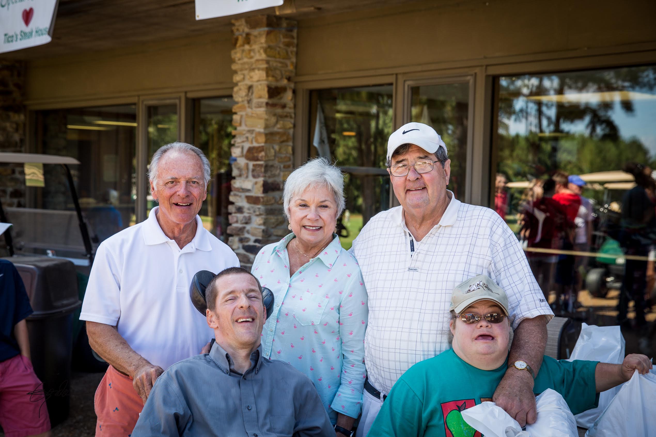 John “Scooter” Chaplain and Eve Walsh (both front row), some of the first Special Kids, with John’s parents and Msgr. Patrick Farrell, who started the Special Kids Program at St. Richard, at the 2015 tournament.