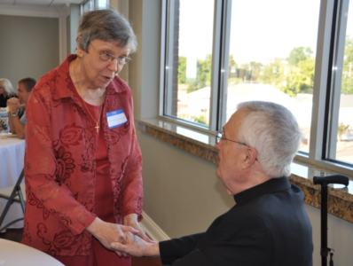 Rosemary Canizaro, longtime parishioner, chats with Bishop Emeritus Joseph Latino after the Mass.