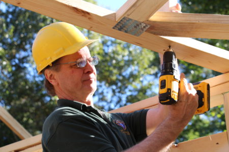 Habitat volunteer Ben Mokry of St. Therese Parish works on the roof. 