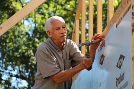 David Joseph of St. Francis of Assisi adds insulation. 