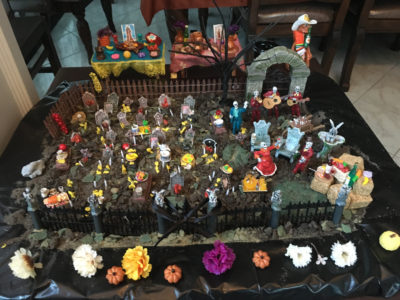 A Day of the Dead cemetery can honor many family members who have died. This model shows how families in Mexico go to the graves of their family members on the Day of the Dead to decorate them and celebrate their lives. Marigold flowers are commonly used in decorations. 