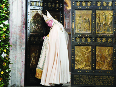 Pope Francis closes the Holy Door of St. Peter's Basilica to mark the closing of the jubilee Year of Mercy at the Vatican Nov. 20. (CNS photo/Tiziana Fabi, pool via Reuters) See POPE-MERCY-CLOSE Nov. 20, 2016.
