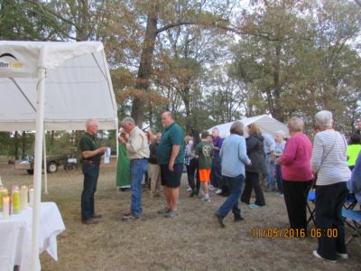 GLUCKSTADT – St. Joseph parishioner Rene Bodin gives Communion to Ken Pribyla during the Knights of Columbus Council 9543 annual rosary, Mass and supper on the grounds of parishioners Chris and Mary Manning’s home in Gluckstadt. (Photo by Sheri Krause) 