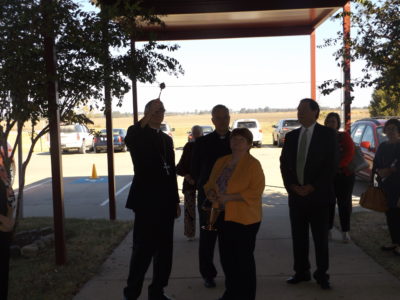 Bishop Joseph Kopacz, left, blesses the new entryway into Greenville St. Joseph and Our Lady of Lourdes school, assisted by Catherine Cook, superintendent of Catholic Schools, and Father Bill Henry, pastor in Greenville. 