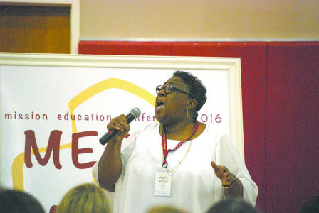 Holly Springs Holy Family Principal Clara Isom leads the choir of educators throughout the conference. Holy Family students also participated in the event.