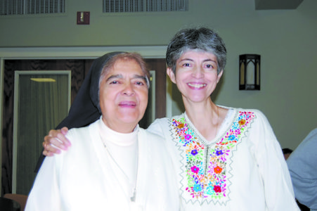 JACKSON – Missionaries Guadalupanas of the Holy Spirit Sisters Lourdes Gonzalez (right) and Obdulia Olivar share a happy smile during the recent meeting of Hispanic ministers in Jackson.