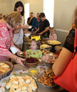 AlliMichel Foster decides what to eat at the luncheon. 