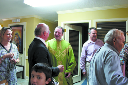 Becky Mitchener, Stan "Tinker" Lauter, Father Jeffrey Waldrep, Danny Waldrep and Matthew Garcia chat at the reception. 