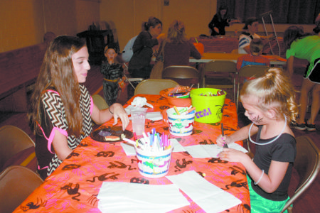 LELAND – St. James Parish youth group and parishioners hosted a “Trunk or Treat” for the children of the parish and community. After a youth Mass, children, dressed in their Halloween costumes, were “treated” to pizza, games and “trick or treating” at tables decorated by individuals and/or families. (Photos by Lisa Zepponi)