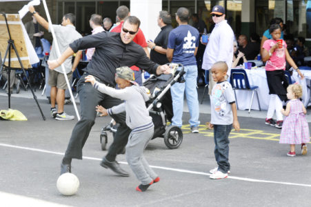 Blake Dubroc, studying for the priesthood for the Diocese of Lafayette, La., plays soccer in New Orleans with a child at the St. Rita Parish picnic Oct. 9. (CNS photo/Peter Finney Jr., Clarion Herald) See SEMINARY-PARISH-PARTNERSHIP Dec. 2, 2016.
