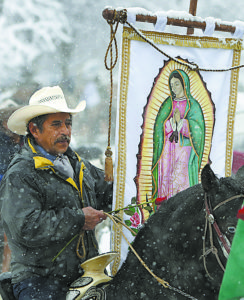 A member of of Club Los Vaqueros Unidos (United Cowboy Club) of Wadsworth, Ill., carries a banner of Our Lady of Guadalupe as he makes his  way to the the Shrine of Our Lady of Guadalupe in Des Plaines, Ill., as part of a pre-celebration for her Dec. 12 feast day. The feast celebrates the appearance of Mary to indigenous peasant St. Juan Diego in 1531 near present-day Mexico City. (CNS photo/Karen Callaway, Catholic New World) See GUADALUPE-RIDERS-SHRINE Dec. 7, 2016.