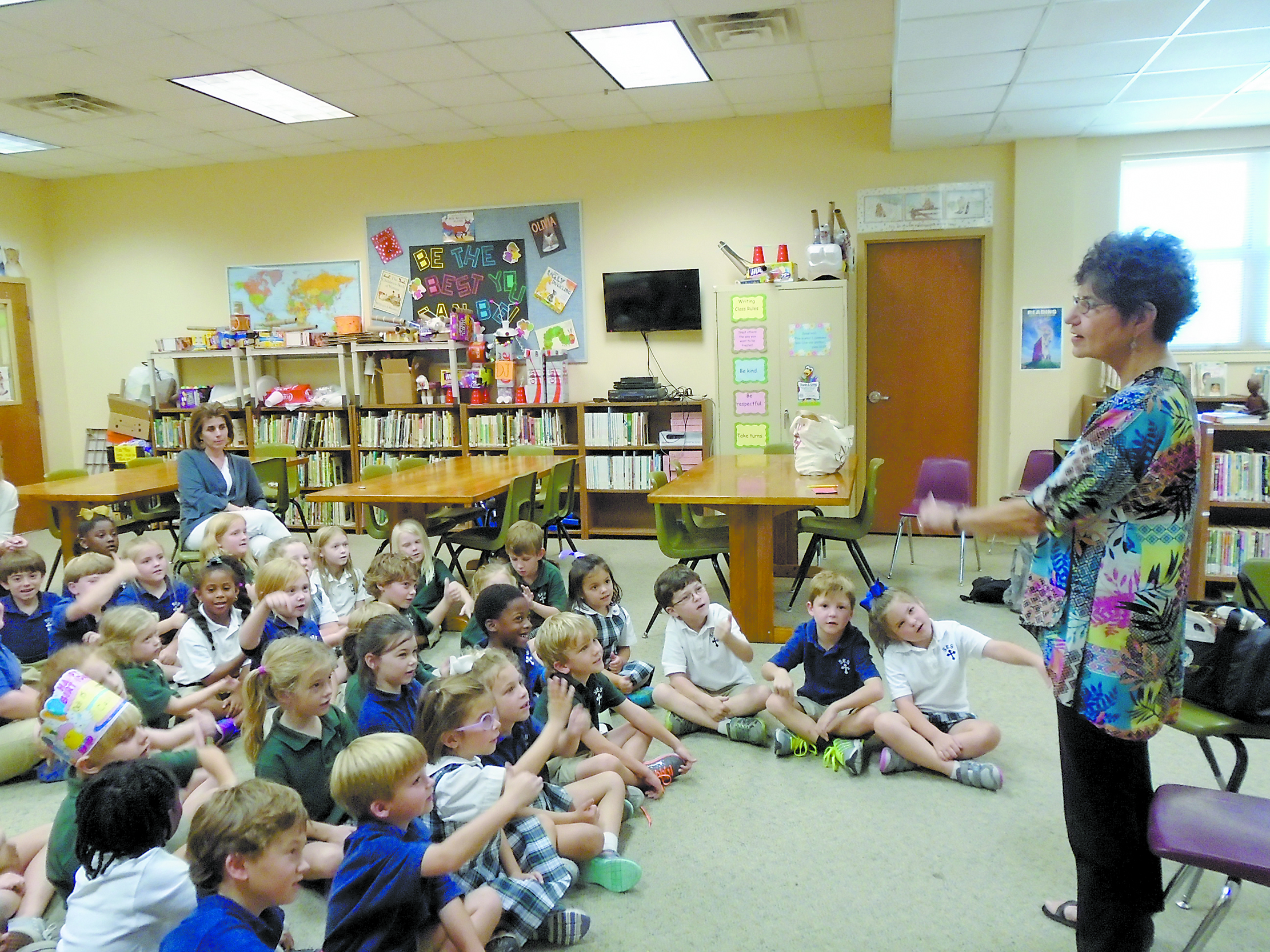 CLARKSDALE – St. Elizabeth School students raise their hands to ask a question to Betty Jo Abraham, a storyteller from Atlanta who recently visited St. Elizabeth School to tell stories to the children from kindergarten through third grade. 