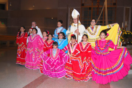 Bishop Joseph Kopacz posed with Hispanic dancers after he celebrated Mass for the 50th anniversary of Christ the King Parish. 