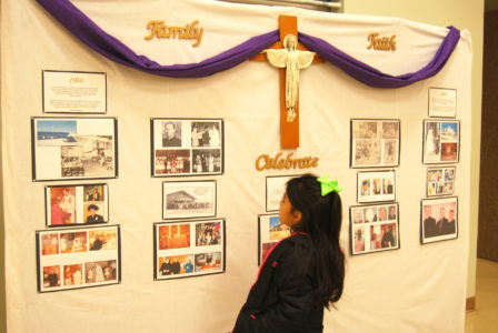 A young member of Christ the King looks at the history display at Christ the King's anniversary celebration. 