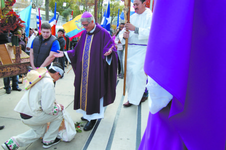 JACKSON – Jesüs Galindo, representing Juan Diego, presents the flowers to Bishop Joseph Kopacz at the beginning of the celebration at the Cathedral of St. Peter the Apostle. (Photo by Elsa Baughman)