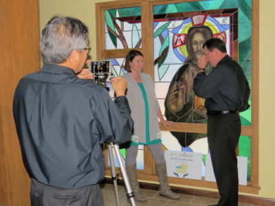 PEARL – Father Joseph Le shoots a video with Father Jeffrey Waldrep and Stacie Wolfe of St. Jude Parish. The team was able to raise $8,000 for their windows through #igiveCatholic.