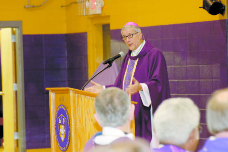 Bishop Joseph Kopacz preaches at the Mass to honor Father Al Camp by naming a building in his honor at Vicksburg Catholic School. 