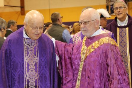 VICKSBURG – Father Al Camp, left, receives congratulations from Father PJ Curley, pastor of St. Michael Parish, after the Mass. (Photos by Holly Chewning.)