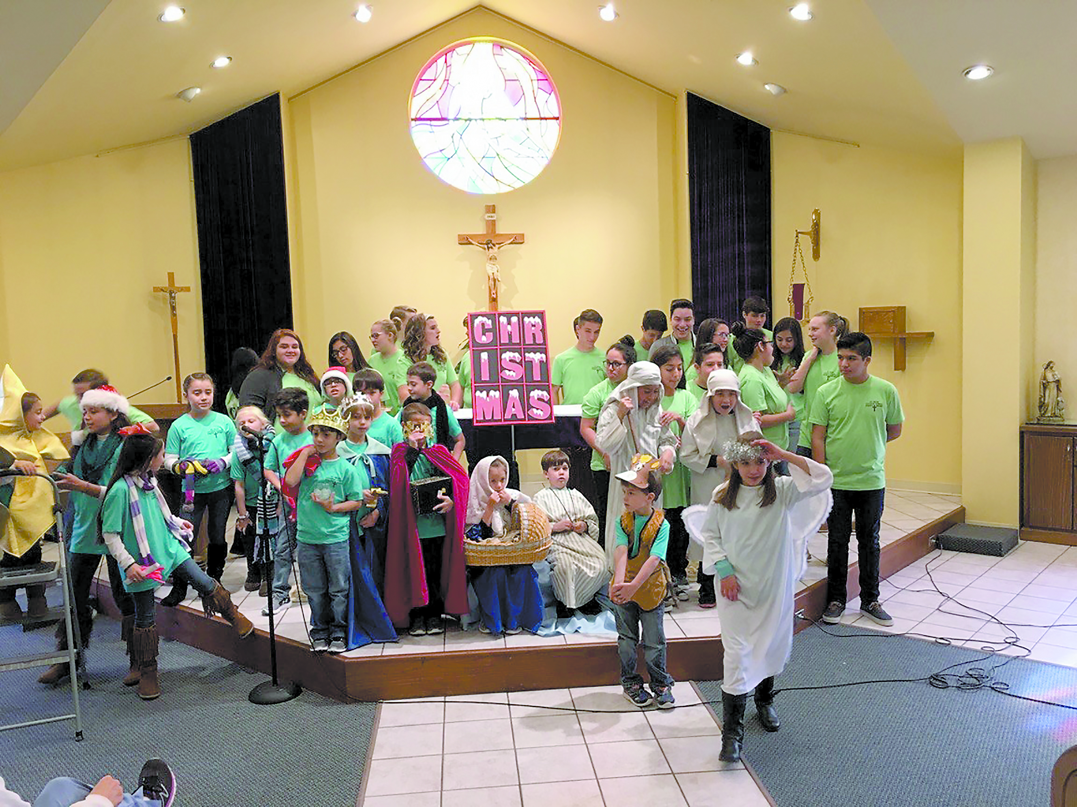 AMORY – St. Helen Parish children prepare at the altar to present the play “The Christmas Window” after Mass Sunday, Dec.11, to celebrate Grandparents’ Day at Christmastime. (Photo by Jean Pinkley)