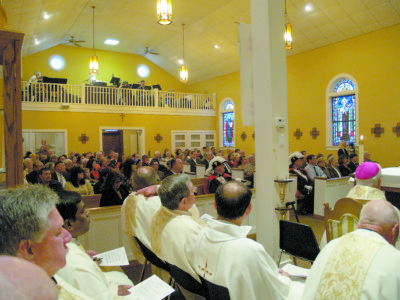 Priests from across the diocese concelebrated the Mass. Many families who have moved away came back for the Mass. (Photos by Maureen Smith.
