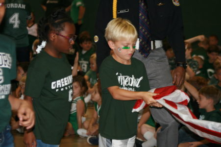 NATCHEZ - Cathedral third-grade students Amani Ishman (left) and Tristan Fondren learning how to properly fold the American flag at the Homes with Heroes program at the school. This program coincided with the school’s Armed Forces football game to educate elementary students on how to properly act during the National Anthem, how the flag was created and how to properly fold the flag. (Photos by Cara Serio)