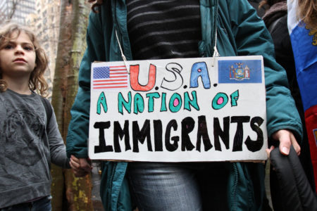 A woman holds a child's hand as they arrive for a rally in support of immigrants' rights in New York City Dec. 18, 2016. Cardinal Daniel N. DiNardo of Galveston-Houston and Archbishop Jose H. Gomez of Los Angeles called attention in a Jan. 6 statement the hardships and contributions of immigrants to American society as the U.S. church prepared to observe National Migration Week. (CNS photo/Gregory A. Shemitz) See USCCB-MIGRATION-HOPE Jan. 6, 2017.