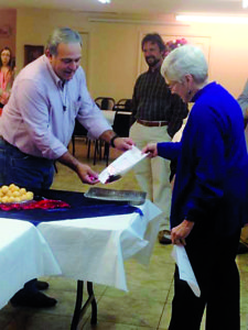 WINONA – Marvin Edwards, OFS, lay ecclesial minister, and Betty Halik Parish Council President, burned the building loan note for Sacred Heart Parish on Dec 31, 2016, following Mass. The parish paid off the loan three years early thanks to “hard work, several fund raisers and generous and dedicated members of Sacred Heart and the community of Winona,” said Cathy Edwards. The parish also dedicated a new lighted sign at the celebration. (Photo by Cathy Edwards)