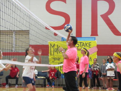 JACKSON -- Father John Bohn, pastor, spikes a ball during the students versus teachers Newcomb game at St. Richard School. 