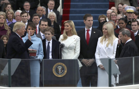 U.S. President Donald Trump places his hand on the Bible as he takes the oath of office administered by U.S. Chief Justice John Roberts Jan. 20. At Trump's side are his wife, Melania, and children Barron, Donald, Ivanka, Eric and Tiffany during his swearing-in as the country's 45th president at the U.S. Capitol in Washington. (CNS photo/Carlos Barria, Reuters) See INAUGURATION- Jan. 20, 2017.
