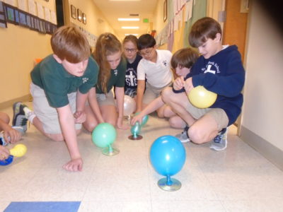 CLARKSDALE – St. Elizabeth, Grace (Gifted) Students are learning about Hover Crafts propelled by air moving from the balloons through the air holes that have been punched in bottle caps glued to CDs.  The Hover Craft rides on the cushion of air between the CD and the floor.